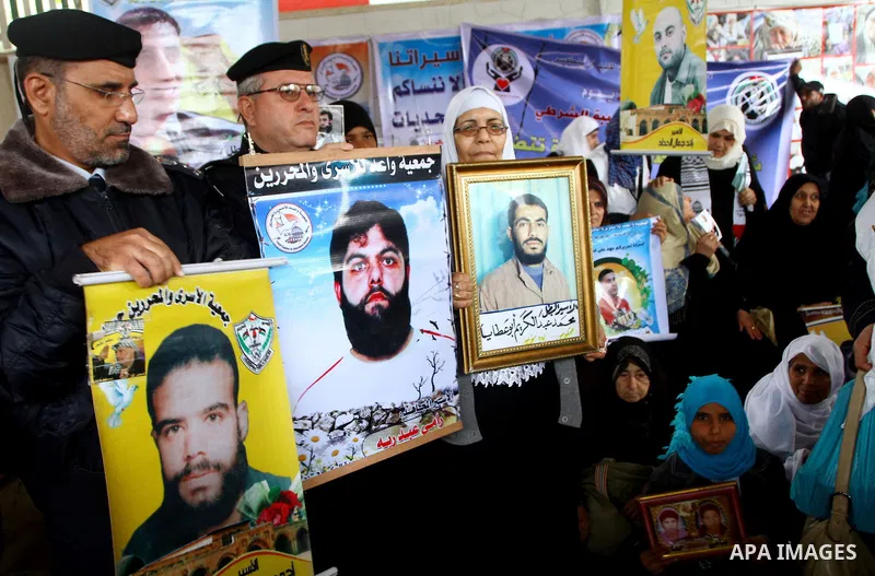 Palestinian security forces in Gaza Strip attend the weekly protest by families of prisoners in the Israeli jails at the Red Cross headquarters in Gaza City, on Dec. 6, 2010. Families of prisoners and the Palestinians se...