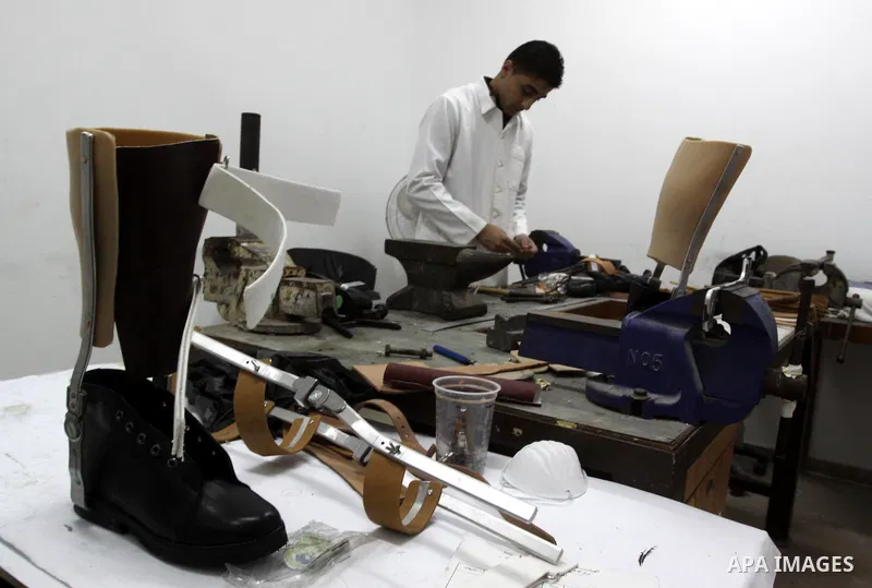 A Palestinian specialist works on artificial limps at the Red Cross for Palestinians who lost their legs and hands in Gaza City on Dec 6,2010 Photo by Mohammed Asad