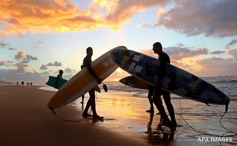 Palestinian youths practise their sport ( riding the waves ) during sunset in Gaza city beach on Dec. 6,2010. Photo by Ashraf Amra