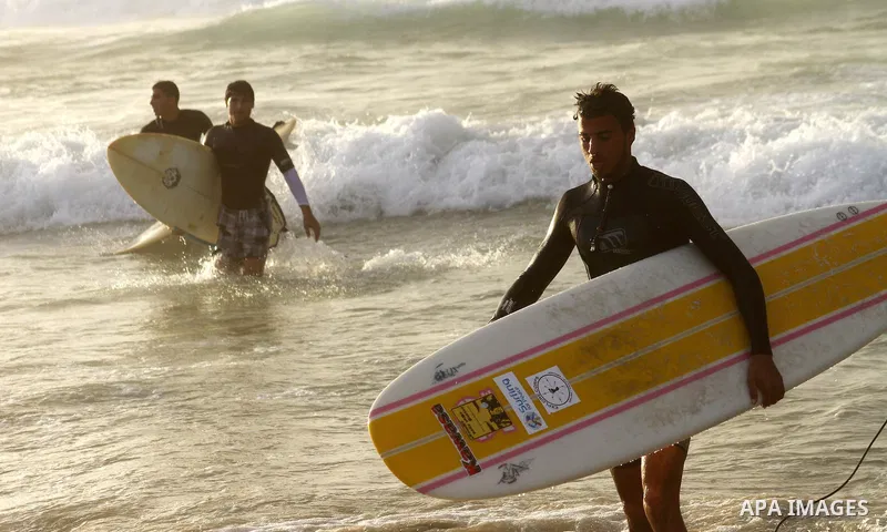 Palestinian youths practise their sport ( riding the waves ) during sunset in Gaza city beach on Dec. 6,2010. Photo by Ashraf Amra