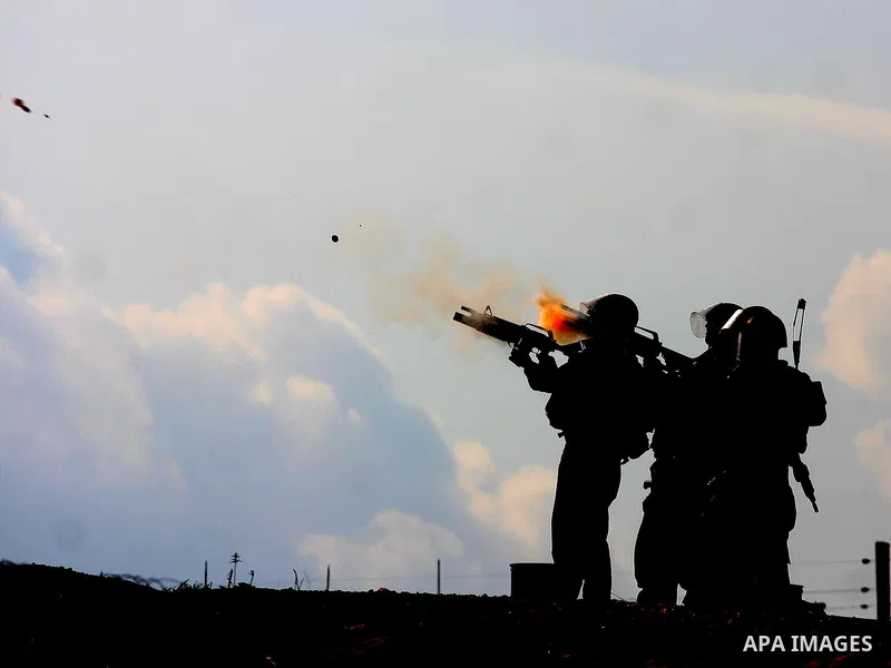 Israeli soldiers fire tear gas during a demonstration against the construction of the Israeli controversial separation barrier in the West Bank village of Bilin near Ramallah on, Dec. 10, 2010. Photo by Issam Rimawi