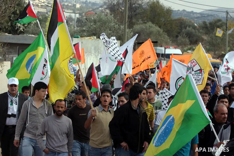 Palestinian protesters take part in a protest against the construction of the Israeli controversial separation barrier in the West Bank village of Bilin near Ramallah on, Dec. 10, 2010. Photo by Issam Rimawi