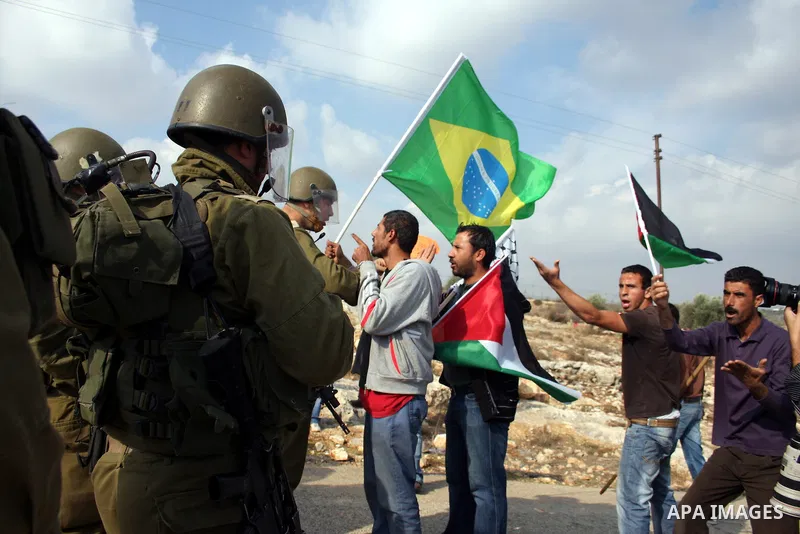 Palestinian protesters take part in a protest against the construction of the Israeli controversial separation barrier in the West Bank village of Bilin near Ramallah on, Dec. 10, 2010. Photo by Issam Rimawi