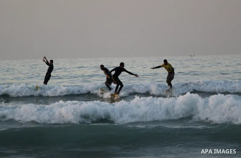 Palestinian youths surf at the beach of Gaza City on December 16, 2010. Photo by Mohammed Asad