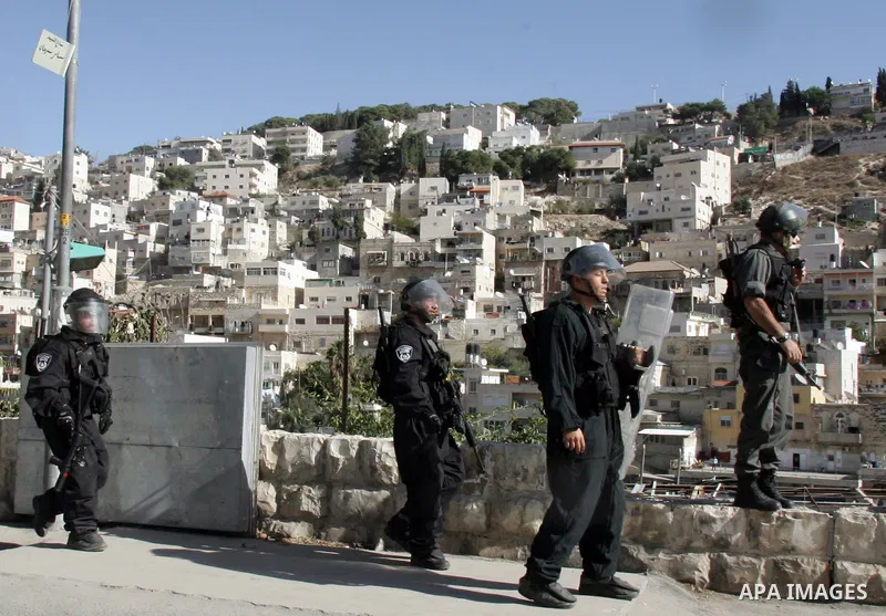 Israeli riot policemen stand guard during a protest by stone-throwing Palestinians after the weekly Friday prayers on December 17, 2010 in the Arab east Jerusalem neighbourhood of Silwan against Jewish settlement in Pale...