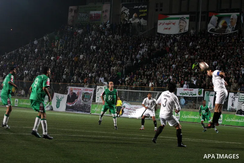Football match between Hebron Youth Club, and the Club of Zahria(Green) in the Premier division games in the Faisal Husseini Stadium in Al-Ram north of Jerusalem,on December 18, 2010.Ended the match in a draw,(1-1). Phot...