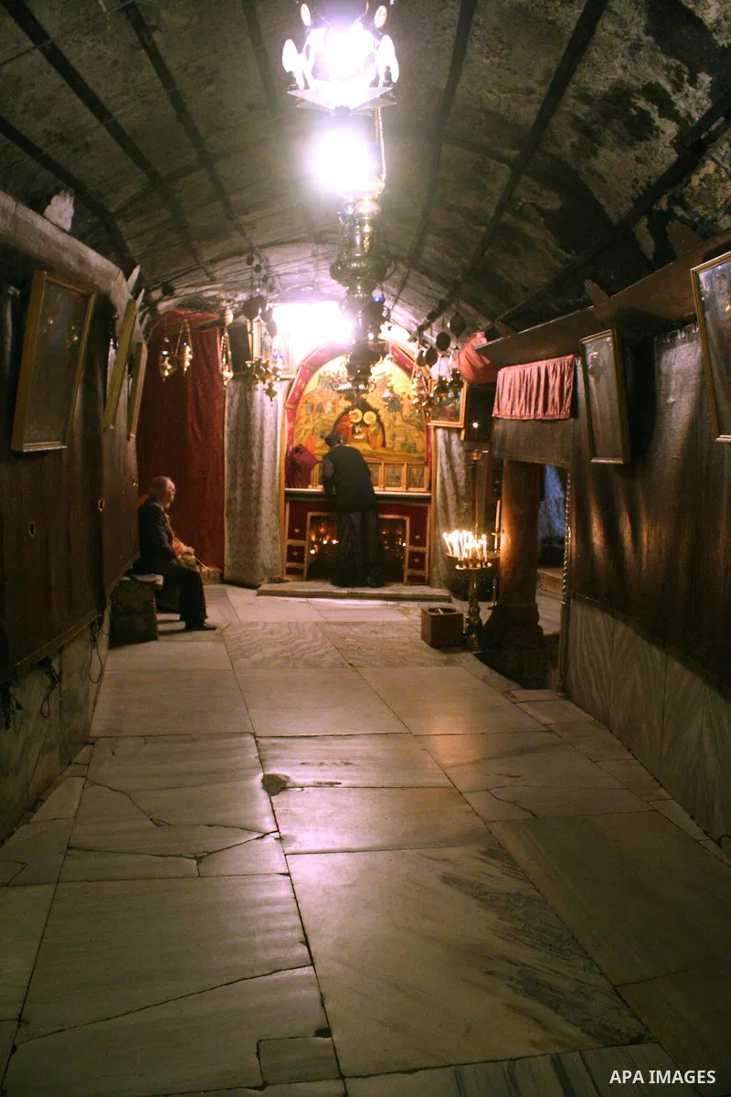 An orthodox priest cleans in the 'Grotto,' or cave in the Church of the Nativity in the biblical West Bank city of Bethlehem on December 19, 2010 as part of the preparations for the Orthodox faith's Christmas celebration...