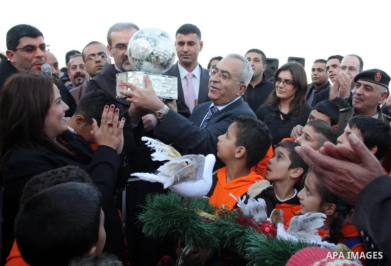 Palestinian Prime Minister Salam Fayyad takes part during a Christmas parade in the West Bank city of Bethlehem on 23 December 2010. Scores of Christian pilgrims are preparing to gather in the traditional birthplace of J...