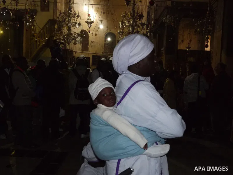 Nigerian Christian pilgrims gather for prayers at the Church of the Nativity, believed to be the birthplace of Jesus Christ, in the West Bank town of Bethlehem on December 24, 2010 as the Holy Land prepared to mark Chris...