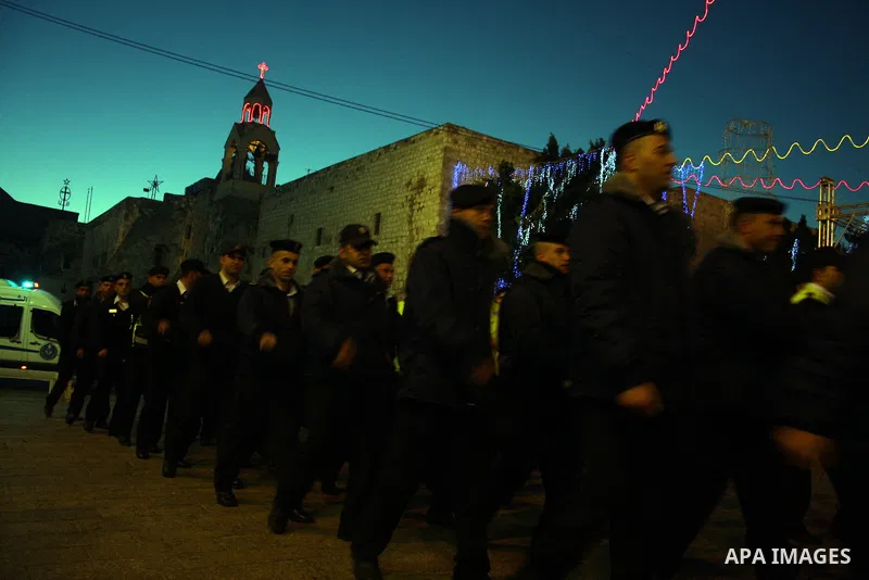 Palestinian security forces march outside the Church of the Nativity, believed to be the birthplace of Jesus Christ, in the West Bank town of Bethlehem on December 24, 2010 as the Holy Land prepared to mark Christmas. Th...