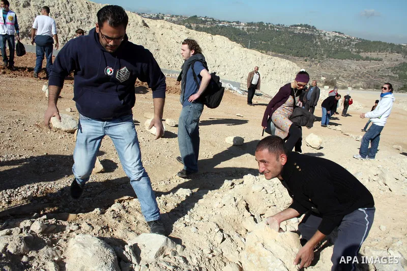 Palestinian and foreign demonstrators take part in a protest against Israel's controversial separation barrier in the West Bank village of Walajah near the biblical town of Bethlehem on 24 December 2010.. Photo by Najeh...
