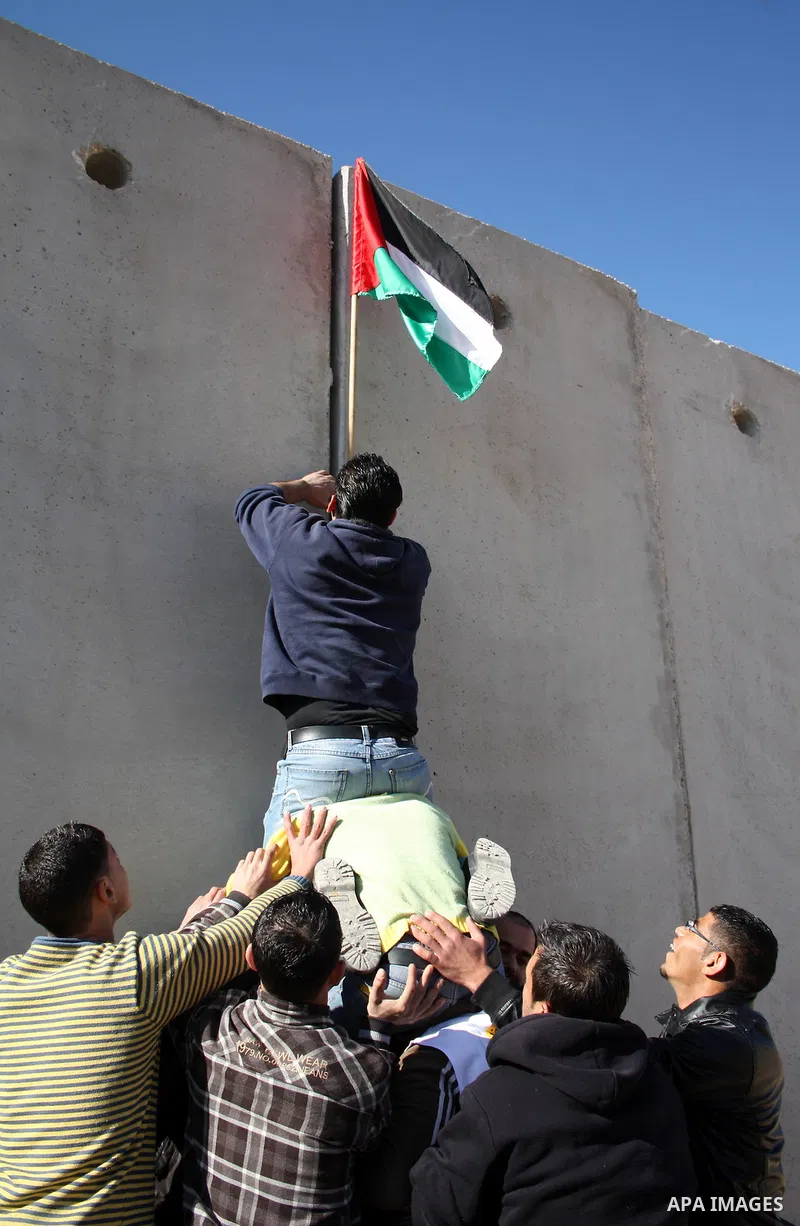 Palestinian and foreign demonstrators take part in a protest against Israel's controversial separation barrier in the West Bank village of Walajah near the biblical town of Bethlehem on 24 December 2010.. Photo by Najeh...