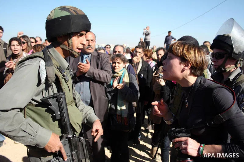 Palestinian and foreign demonstrators argue with Israeli soldiers during a protest against Israel's controversial separation barrier in the West Bank village of Walajah near the biblical town of Bethlehem on 24 December...
