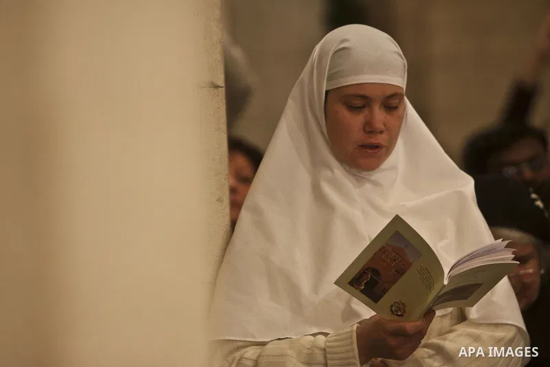 A Nun Prays as Latin Patriarch of Jerusalem Fouad Twal (Not Pictured) leads Christmas midnight mass at the Church of the Nativity in the West Bank town of Bethlehem early Dec. 25, 2010. Photo by Fadi Arouri \ POOL