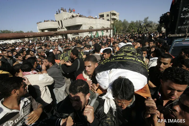 Palestinian mourners carry the bodies of two Palestinian militants during their funeral in Khan Younis, southern Gaza Strip, on Dec. 26, 2010. Israeli forces killed two Palestinian militants Sunday morning in armed clash...