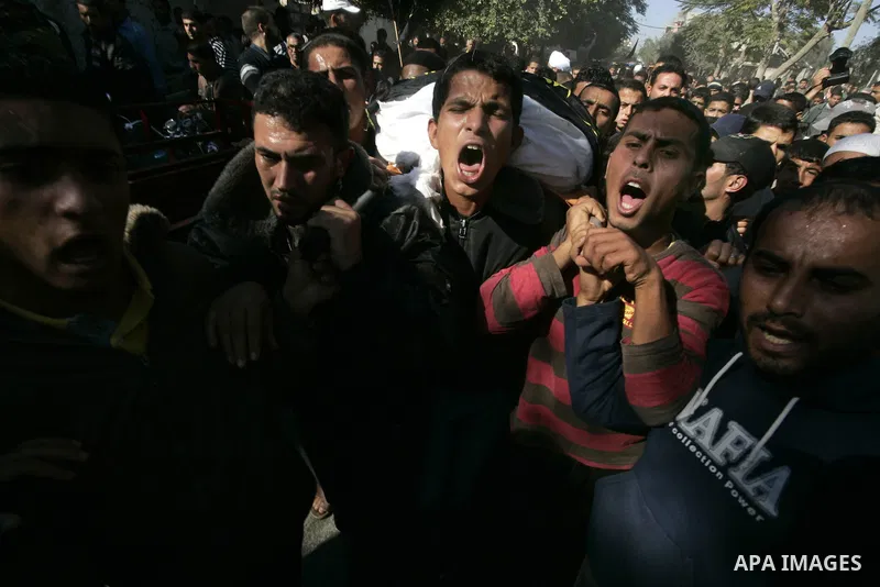 Palestinian mourners carry the body of Islamic Jihad militant Musaab Abu Rock during his funeral along with comrade Mahmud Al-Najjar, who were killed in an exchange of fire with Israeli soldiers on the border of Gaza, in...