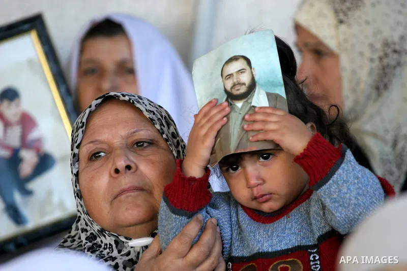 Palestinians hold pictures of their prisoned relatives in Israeli jails as they gather in a weekly activity calling for their liberty at the Red Cross headquarters in Gaza City on December 27, 2010. About 7000 prisoners...