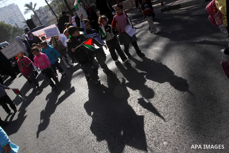 Palestinian children protest during a demonstration marking the 2nd anniversary of the Israel-Gaza war, in Gaza City on Monday, Dec. 27, 2010. Israel's volatile front with Gaza has been relatively quiet since the overwhe...