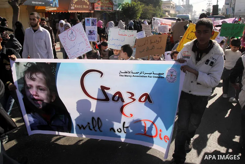 Palestinian children protest during a demonstration marking the 2nd anniversary of the Israel-Gaza war, in Gaza City on Monday, Dec. 27, 2010. Israel's volatile front with Gaza has been relatively quiet since the overwhe...