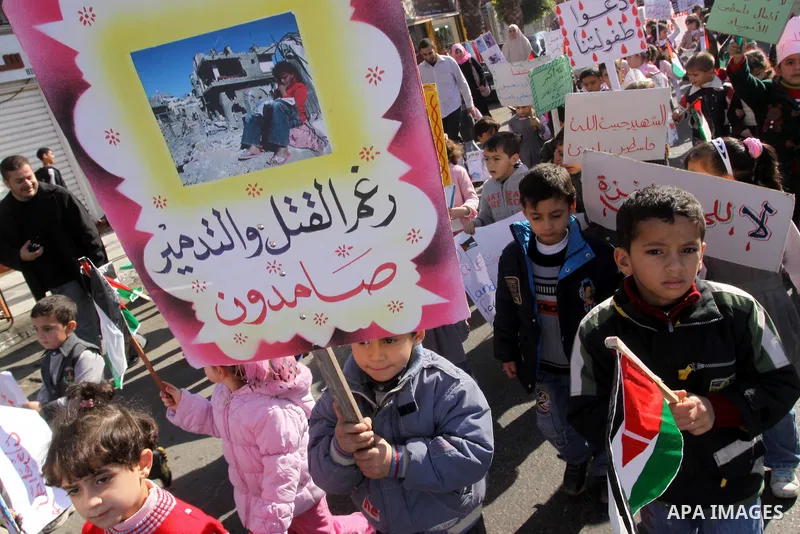 Palestinian children protest during a demonstration marking the 2nd anniversary of the Israel-Gaza war, in Gaza City on Monday, Dec. 27, 2010. Israel's volatile front with Gaza has been relatively quiet since the overwhe...