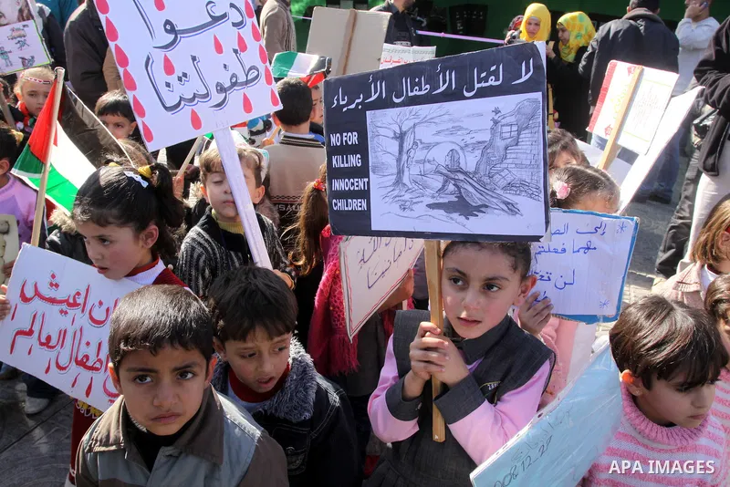 Palestinian children protest during a demonstration marking the 2nd anniversary of the Israel-Gaza war, in Gaza City on Monday, Dec. 27, 2010. Israel's volatile front with Gaza has been relatively quiet since the overwhe...
