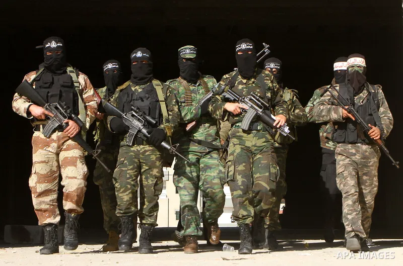 Masked Palestinian militants of the Popular Resistance Committee attend a press conference to mark the 2nd anniversary of the Israeli war on Gaza, in Gaza City, Dec. 27, 2010. A Fatah senior member on Monday called on Is...