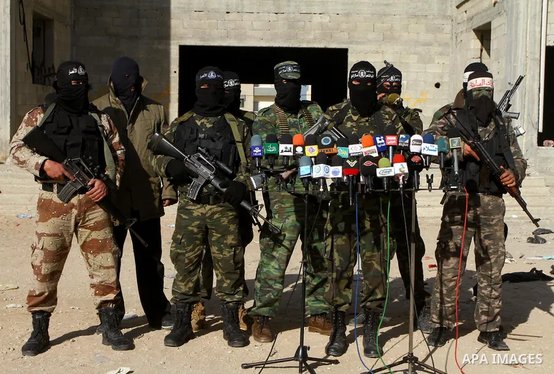 Masked Palestinian militants of the Popular Resistance Committee attend a press conference to mark the 2nd anniversary of the Israeli war on Gaza, in Gaza City, Dec. 27, 2010. A Fatah senior member on Monday called on Is...