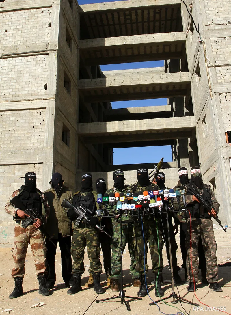 Masked Palestinian militants of the Popular Resistance Committee attend a press conference to mark the 2nd anniversary of the Israeli war on Gaza, in Gaza City, Dec. 27, 2010. A Fatah senior member on Monday called on Is...
