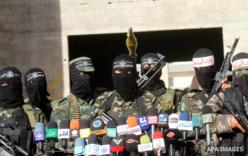 Masked Palestinian militants of the Popular Resistance Committee attend a press conference to mark the 2nd anniversary of the Israeli war on Gaza, in Gaza City, Dec. 27, 2010. A Fatah senior member on Monday called on Is...