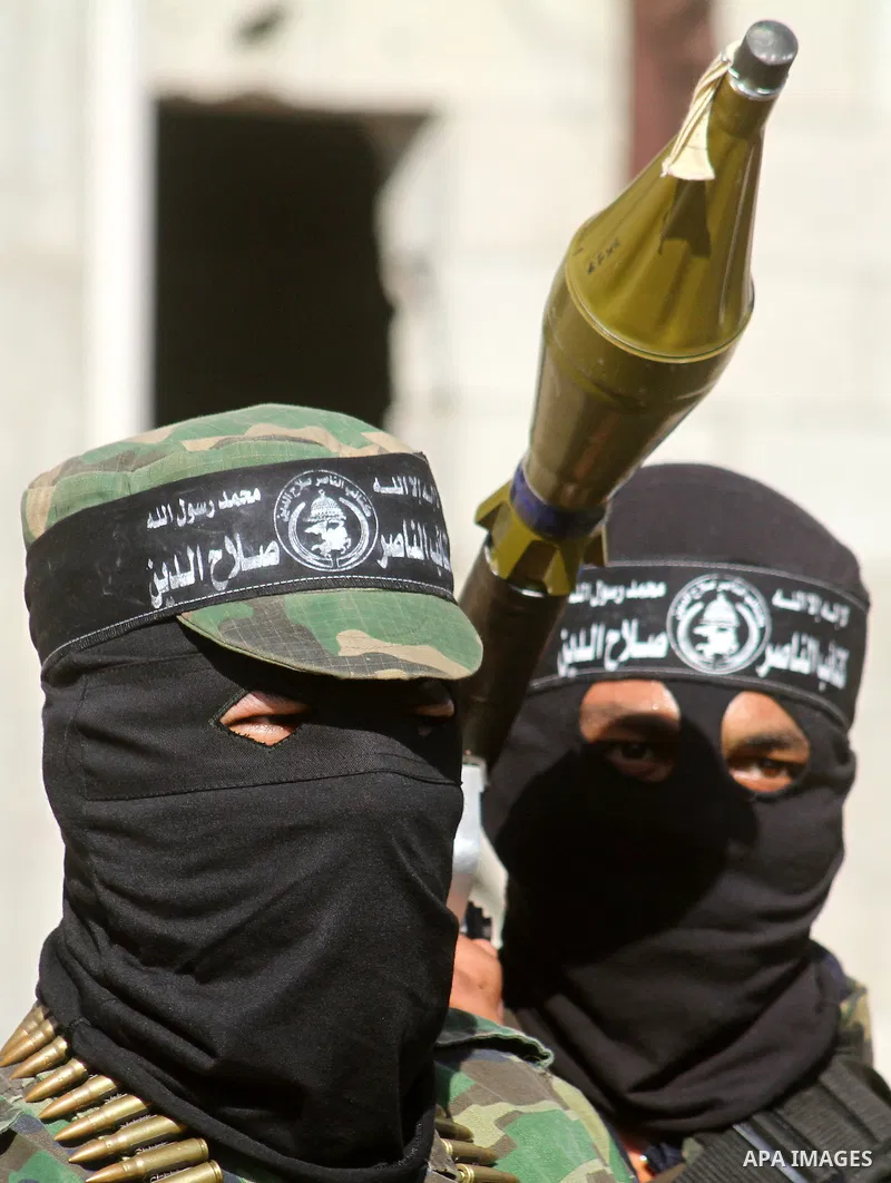 Masked Palestinian militants of the Popular Resistance Committee attend a press conference to mark the 2nd anniversary of the Israeli war on Gaza, in Gaza City, Dec. 27, 2010. A Fatah senior member on Monday called on Is...