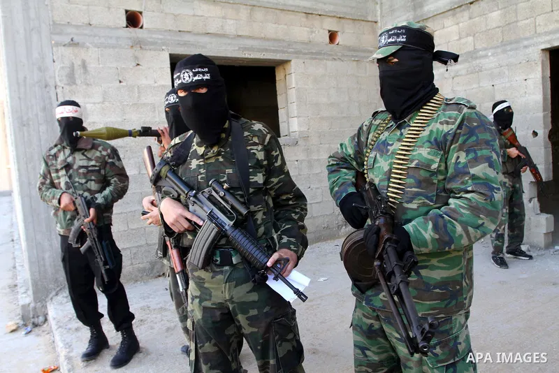 Masked Palestinian militants of the Popular Resistance Committee attend a press conference to mark the 2nd anniversary of the Israeli war on Gaza, in Gaza City, Dec. 27, 2010. A Fatah senior member on Monday called on Is...