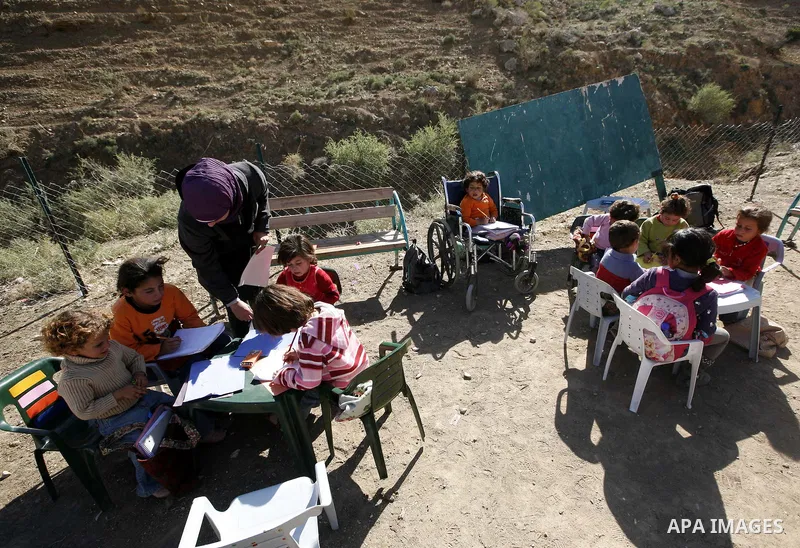 Palestinian students receive their education under the sun and cold weather, in the valley of salt near the Jordan Valley,Tuesday, Dec. 28, 2010. Photo by Wagdi Eshtayah