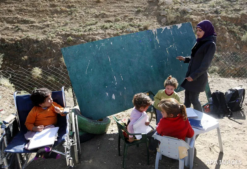 Palestinian students receive their education under the sun and cold weather, in the valley of salt near the Jordan Valley,Tuesday, Dec. 28, 2010. Photo by Wagdi Eshtayah