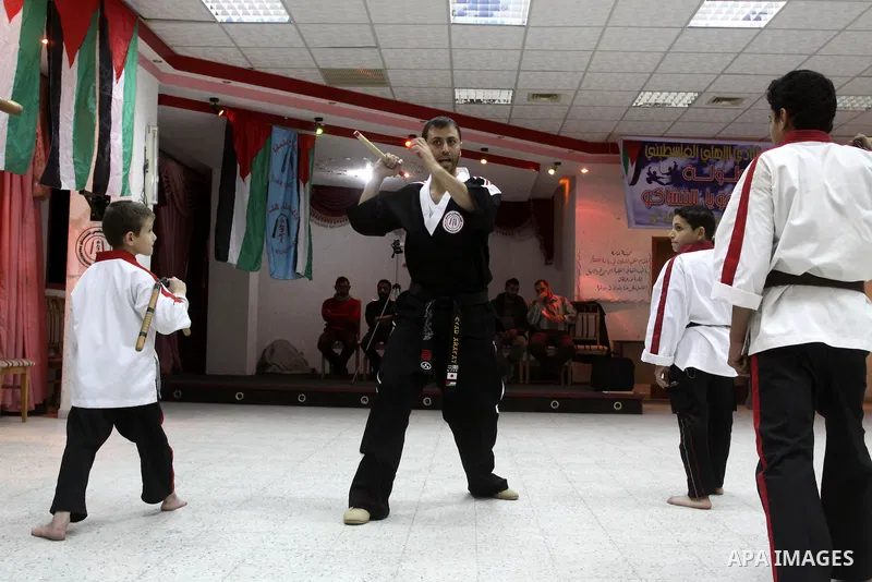 The Palestinian champion in Nunchaku sport, Eyad Arafat during his training for Nunchaku students in Al-Ahly club in Gaza City on Dec. 28,2010. Eyad Arafat is a world champion and founder of a Palestinian way in the Nunc...