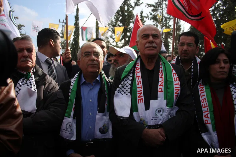 Palestinian Prime Minister, Salam Fayyad take part in a protest against Israel's separation barrier outside the West Bank village of Bilin, near Ramallah, Friday, Dec 31, 2010. Israel says the barrier is necessary for se...
