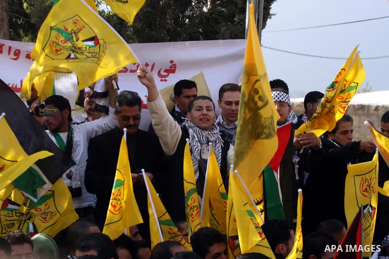 Palestinians take part in a protest against Israel's controversial separation barrier in the village of Bilin, near the West Bank city of Ramallah, on December 31, 2010. Photo by Issam Rimawi