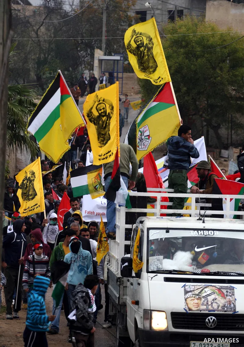 Palestinians take part in a protest against Israel's controversial separation barrier in the village of Bilin, near the West Bank city of Ramallah, on December 31, 2010. Photo by Issam Rimawi