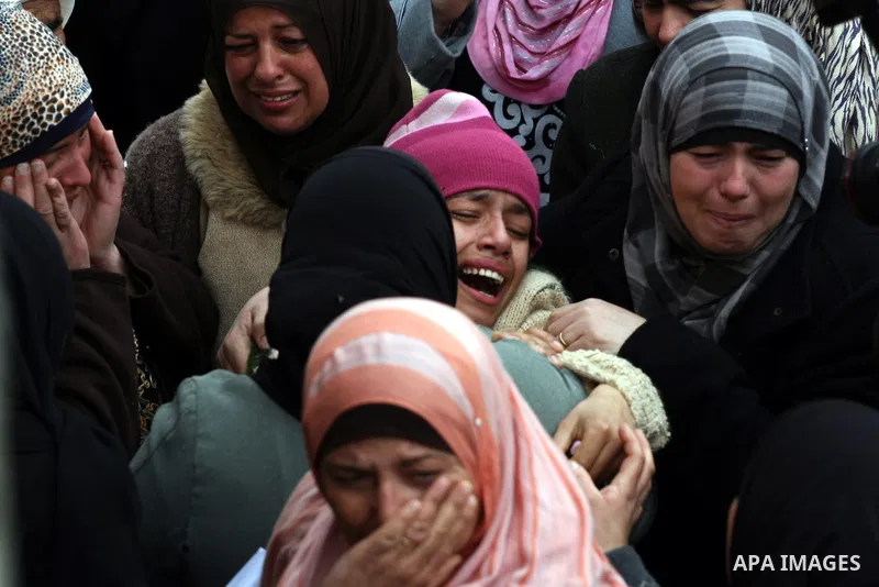 A sister of Jawaher Abu Rahmah is supported by other mourners during the funeral of Jawaher Abu Rahmah at the West Bank Village of Bil'in, on 01 January 2011. Jawaher, 36, who was protesting against Israel's West Bank se...