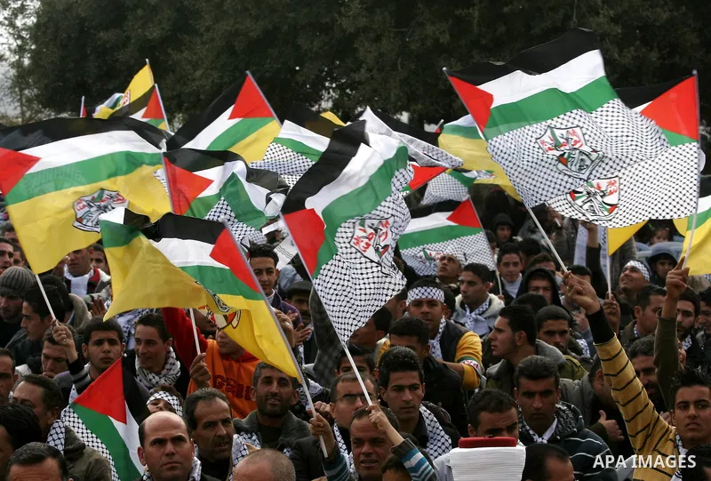 Palestinian Fatah supporters gather during a rally to mark the upcoming 46th anniversary since the group's foundation in the West Bank town of Toura Al-Gharbeyyeh, near Jenin, Saturday, Jan. 1, 2011. Photo by Wagdi Eshta...