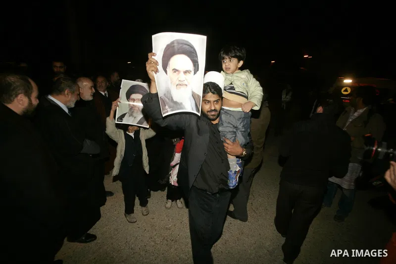 Pro-Palestinian activists from Asia 1 convoy hold pictures of leader of the 1979 Iranian Revolution ,Khomeini upon their arrival to the Gaza Strip through Rafah border crossing between Egypt and southern Gaza Strip, Jan....