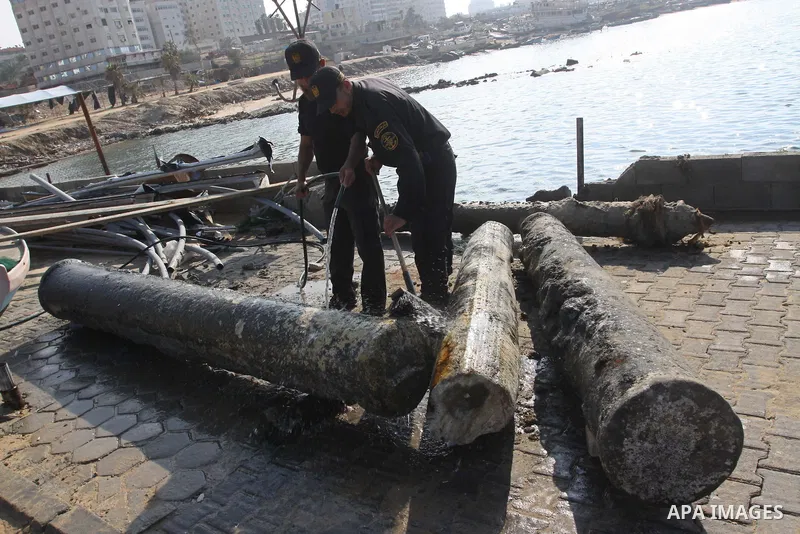 Members of Palestinian naval policemen clean an ancient columns older than 1300 years belonging to palace from the Roman era in the port of Gaza City on Dec. 3,2010. Photo by Mohammed Asad