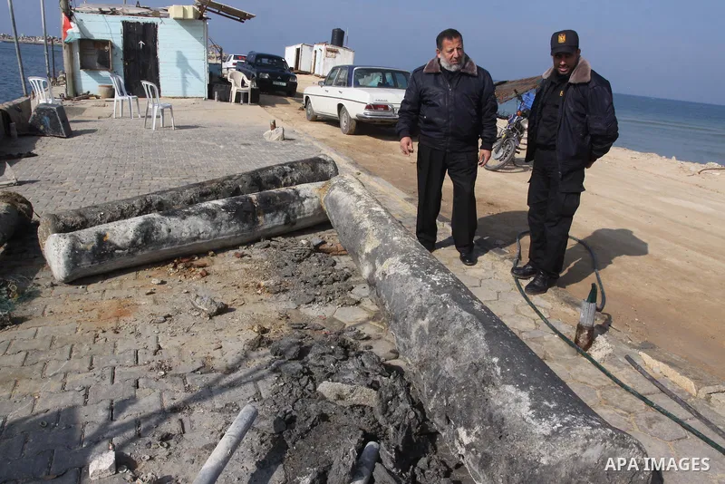 Members of Palestinian naval policemen stand near an ancient columns older than 1300 years belonging to palace from the Roman era in the port of Gaza City on Dec. 3,2010. Photo by Mohammed Asad