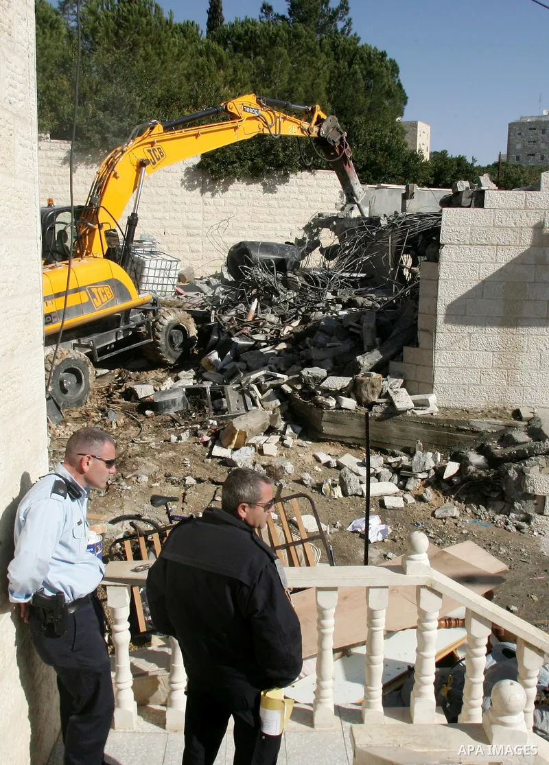 An Israeli bulldozer destroys a Palestinian house in the Sheikh Jarrah neighbourhood of East Jerusalem January 3, 2011. The house was destroyed by Israeli municipality bulldozers for allegedly being built without a permi...