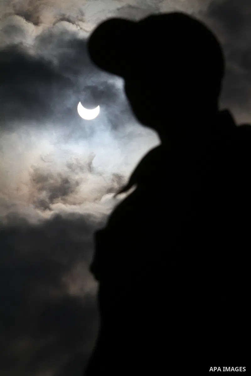Picture shows the silhouette of a Palestinian man against the sky during a partial solar eclipse, in Gaza City on Tuesday 04 January 2011. The partial eclipse was visible near sunrise over most of Europe and northeastern...