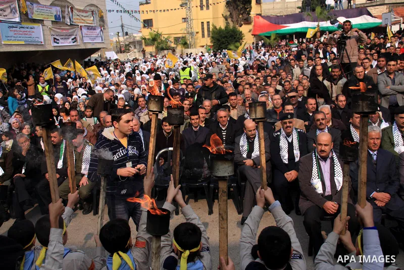 Palestinian supporters from the Fatah movement participate in a rally marking the 46th anniversary since the group's foundation in the West Bank city of Qalqilya, Tuesday, Jan. 4, 2011. Photo by Wagdi Eshtayah