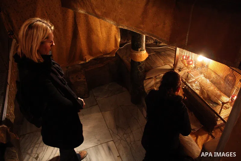 Christian worshippers take part in a prayer in the 'Grotto,' or cave in the Church of the Nativity, traditionally accepted as the birthplace of Jesus Christ, in the West Bank city of Bethlehem on January 05, 2011. Photo...