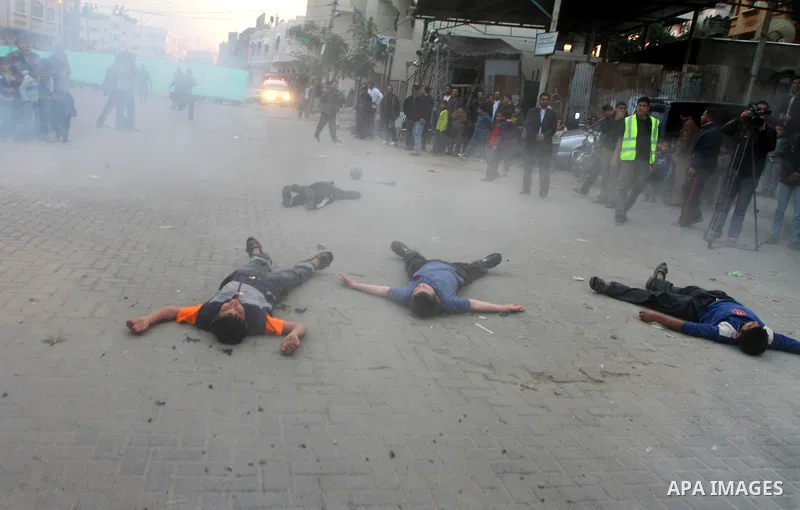 Palestinian youths act as mock injured as they take part in a rally organised by Hamas marking the second anniversary of the Israel-Gaza war in the Jabalia refugee camp in the northern Gaza Strip on January 6, 2011. Phot...