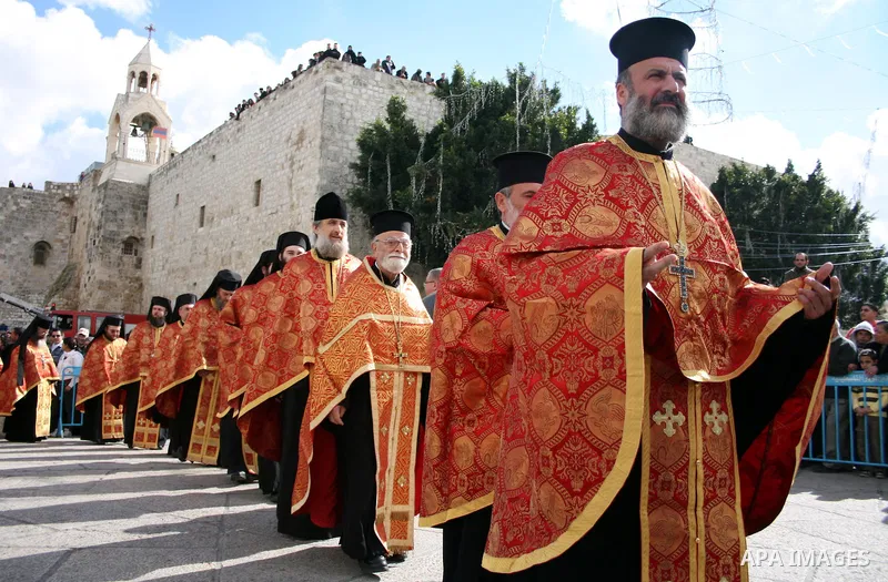 Greek Orthodox Patriarch of Jerusalem Theofilos III waves a censer as he stand in the Nativity church during the Greek Orthodox Christmas Eve in the West Bank city of Bethlehem, Thursday, Jan. 6, 2011. Christmas falls on...