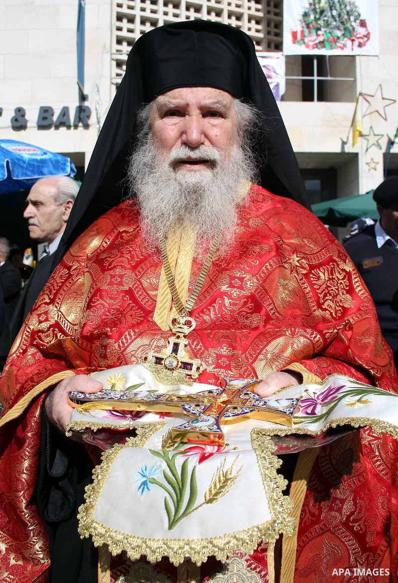 A Greek Orthodox priest takes part in the Christmas procession at Manger Square outside the Church of the Nativity, the traditional birthplace of Jesus Christ, in the West Bank city of Bethlehem on January 6, 2011. The O...