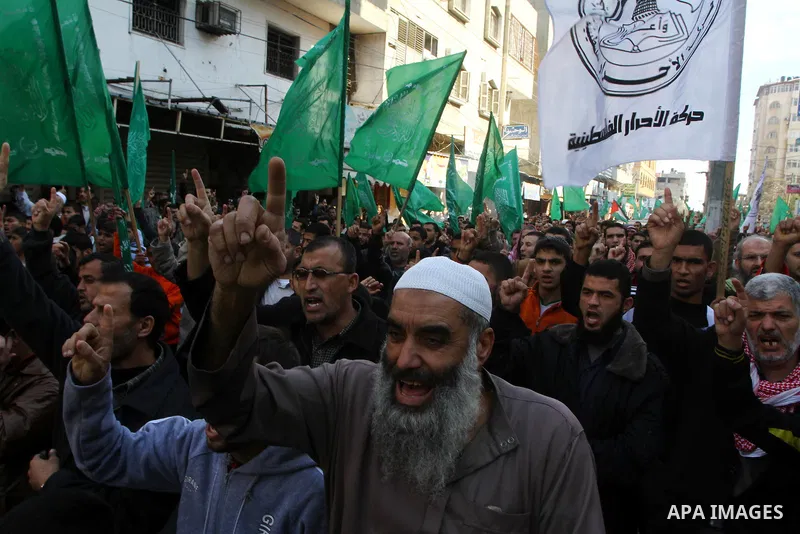 Palestinian Hamas supporters take part in a rally in Gaza city against Mahmud Abbas Authority on Jan. 7,2011. A Palestinian man was shot dead by Israeli soldiers during a raid in the West Bank to arrest suspected militan...